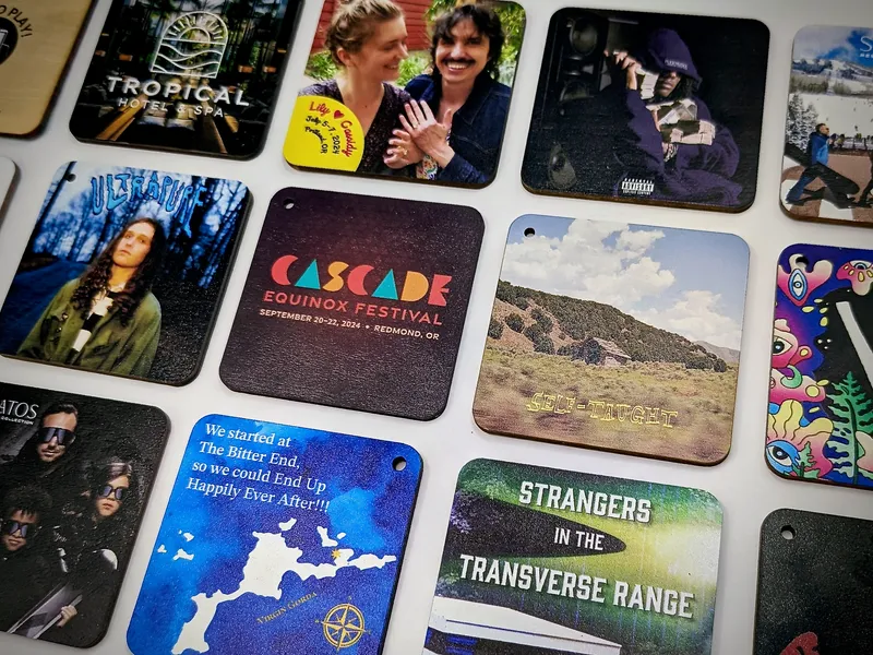 A flat lay of many custom-printed Goodz cards showing various album art and event designs.